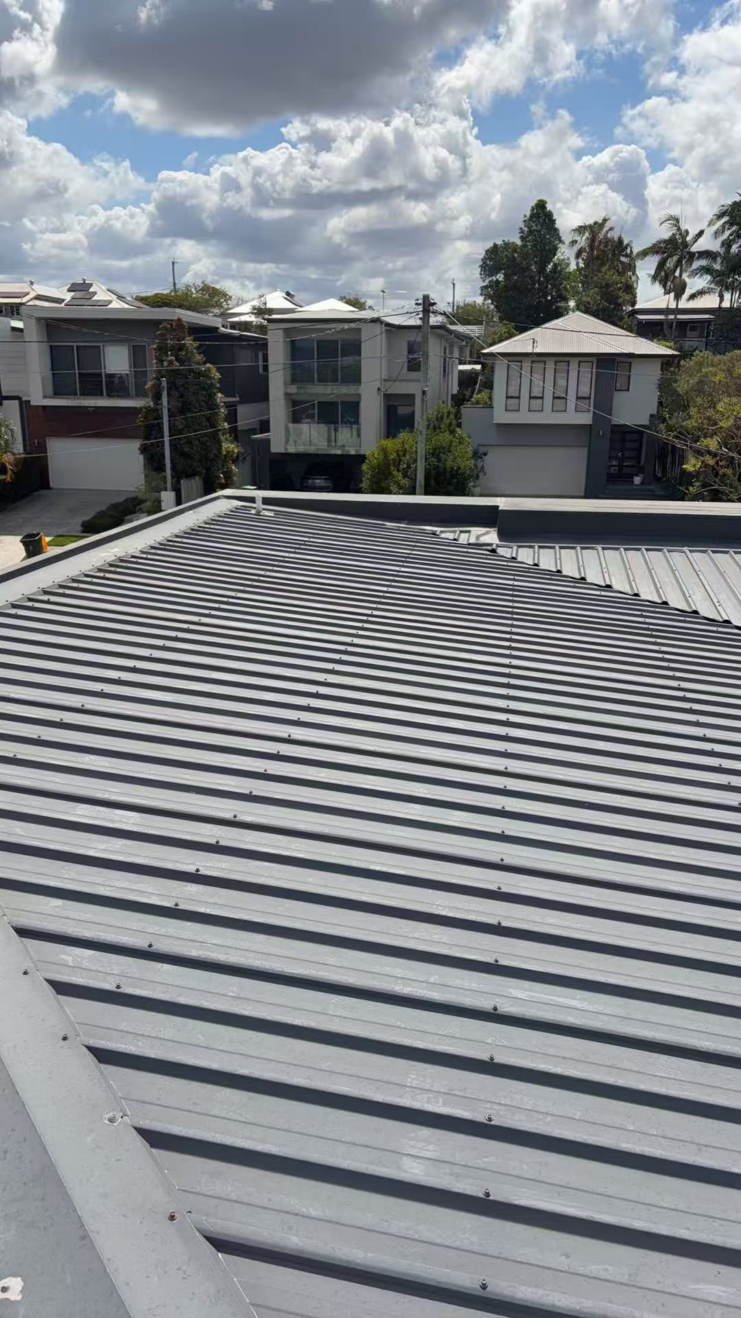 Grey metal roof slope viewed from above