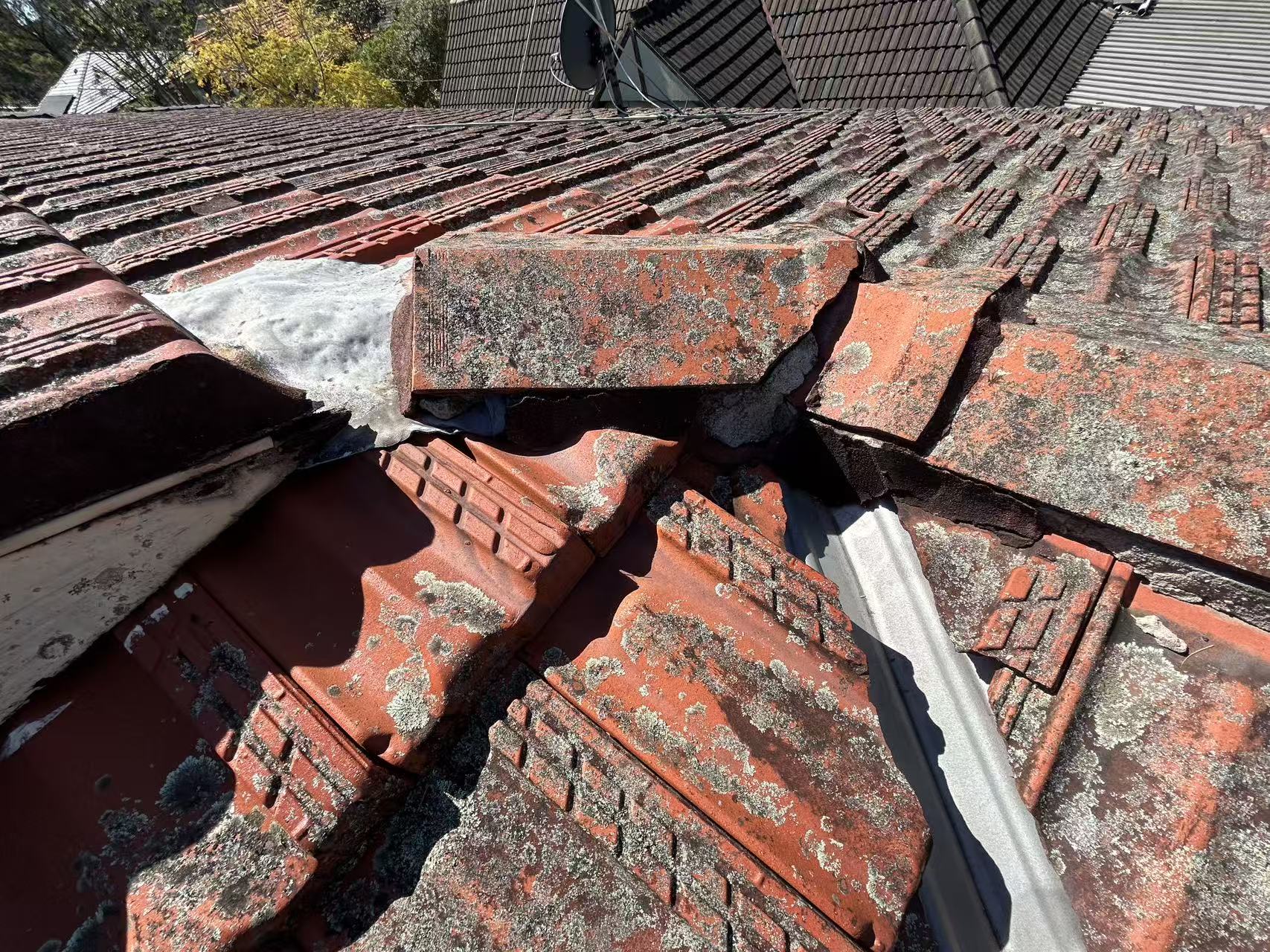 Damaged tiles around a roof valley junction