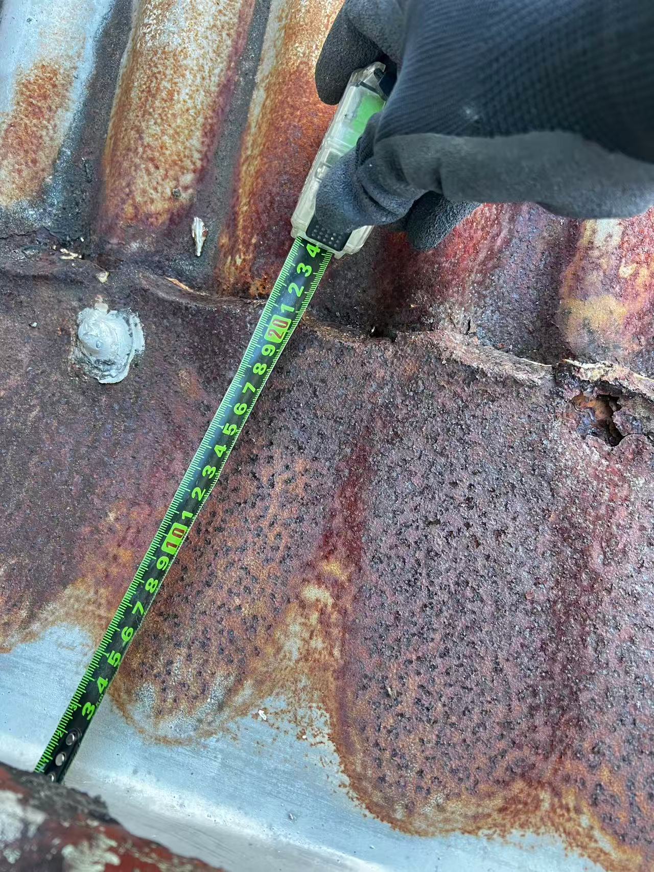 Site measurement across a deteriorated metal roof junction