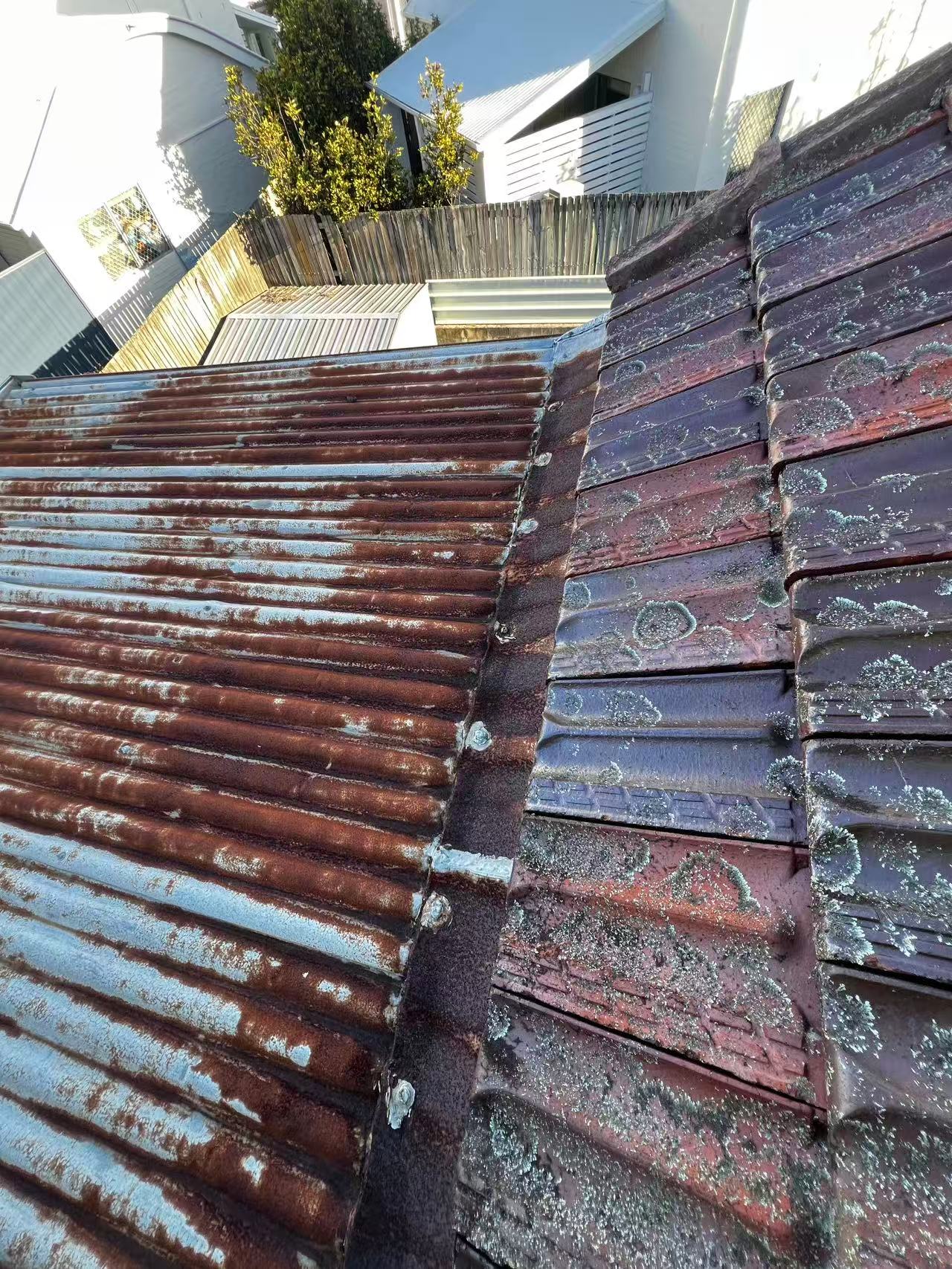 Wider view of the corroded metal-to-tile roof junction