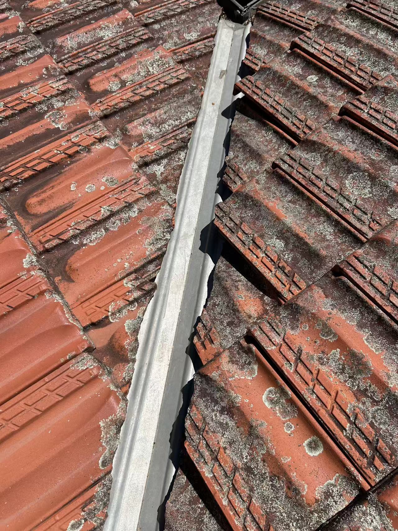 Metal valley channel between tiled roof slopes