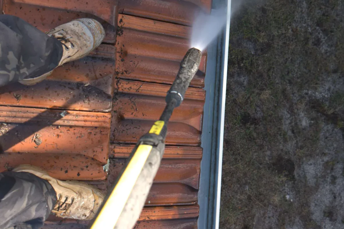 Cleaning beside a tiled roof and gutter at a Sydney property